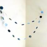 Blue garland with paper flo..